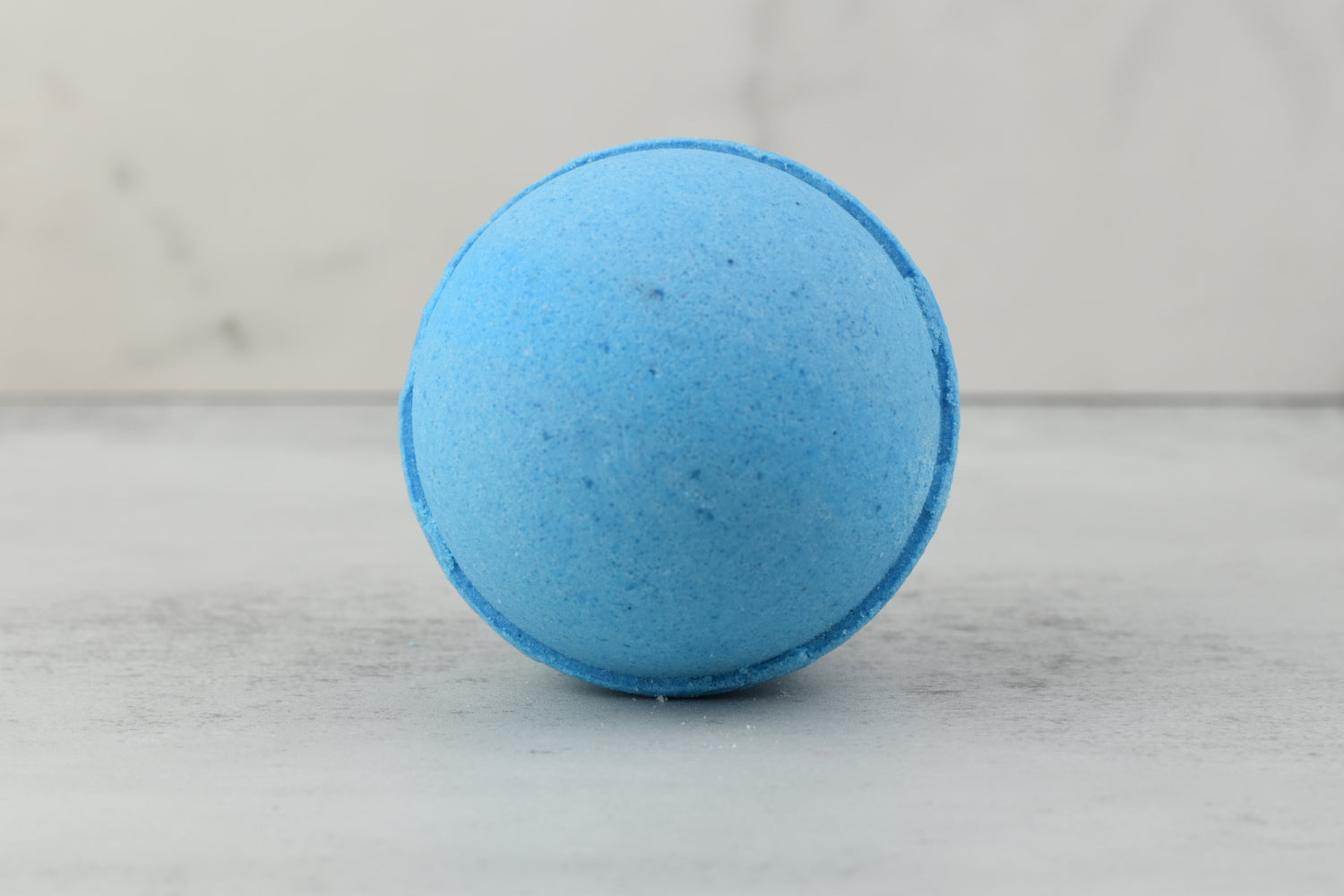 Verbena Vitality Organic Bath Bomb with essential oils like cedarwood and rosemary for calming, energy-restoring bath experience.