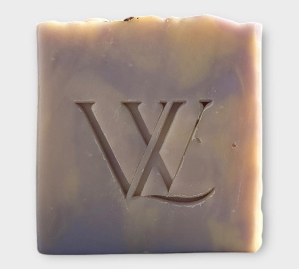 With Love Daydreamer Artisan Soap, part of your essential skin care routine, with lavender and orange essential oils for a soothing and moisturizing wash.