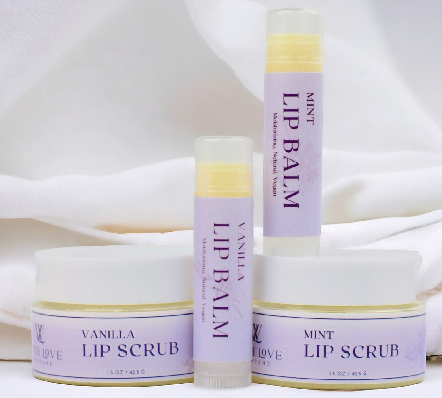 With Love Essential Skin Care Lip Care Duo with exfoliating lip scrub and hydrating lip balm in vanilla or mint for smooth, soft lips.